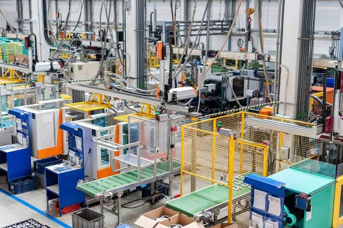Automated production line with conveyor belts, control panels and safety guarding running at full rate