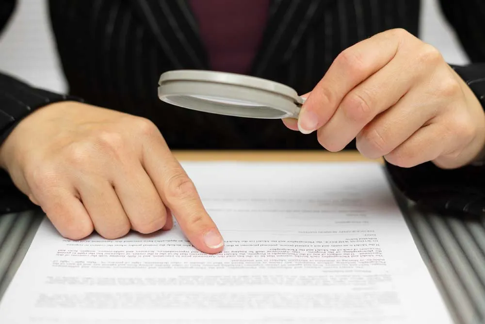 Auditor verifying BSCI and ISO certification documents against the factory record