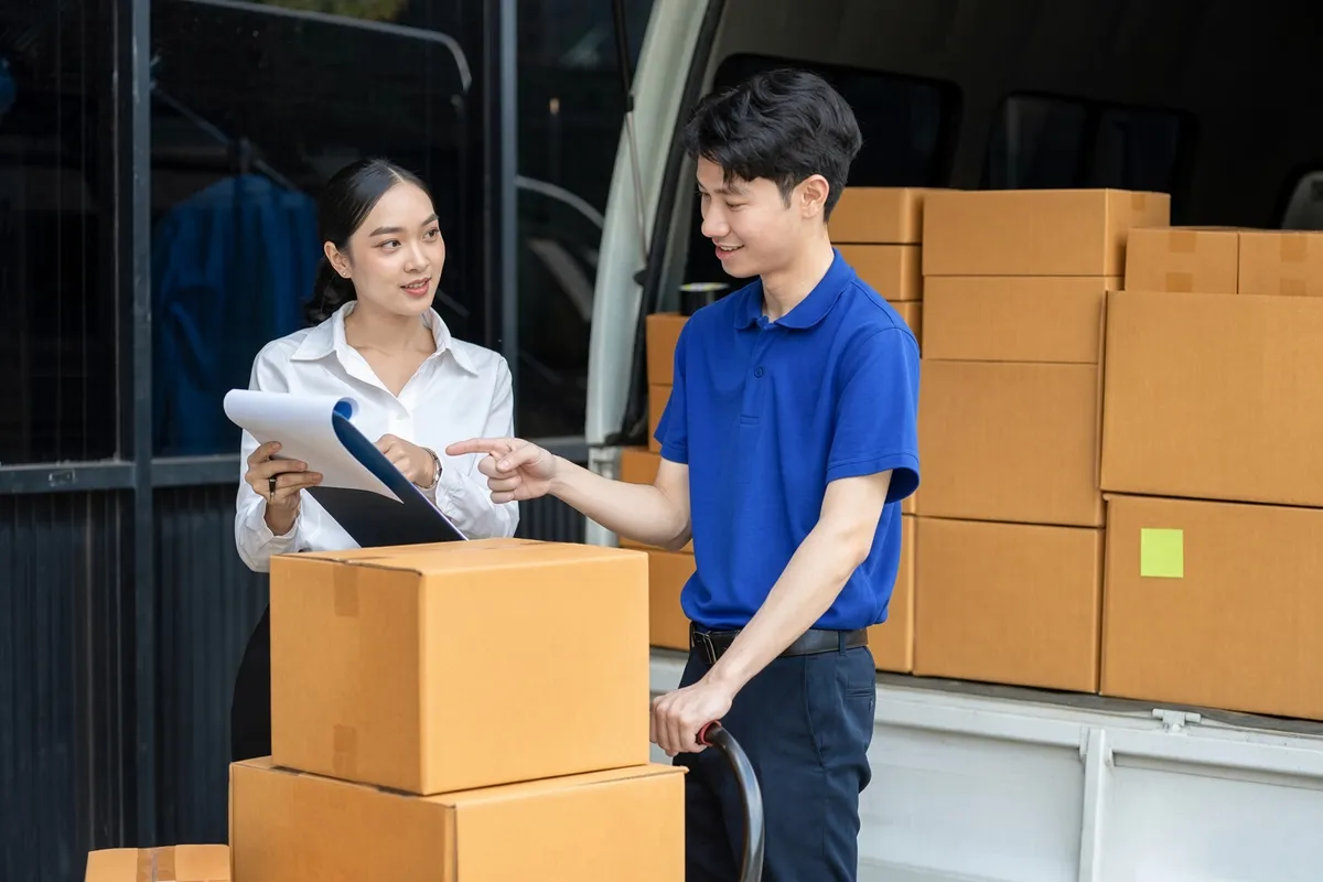 A consignment of cartons checked against the paperwork at a loaded delivery van