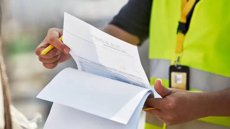 Hands reviewing a printed customs declaration at a border checkpoint