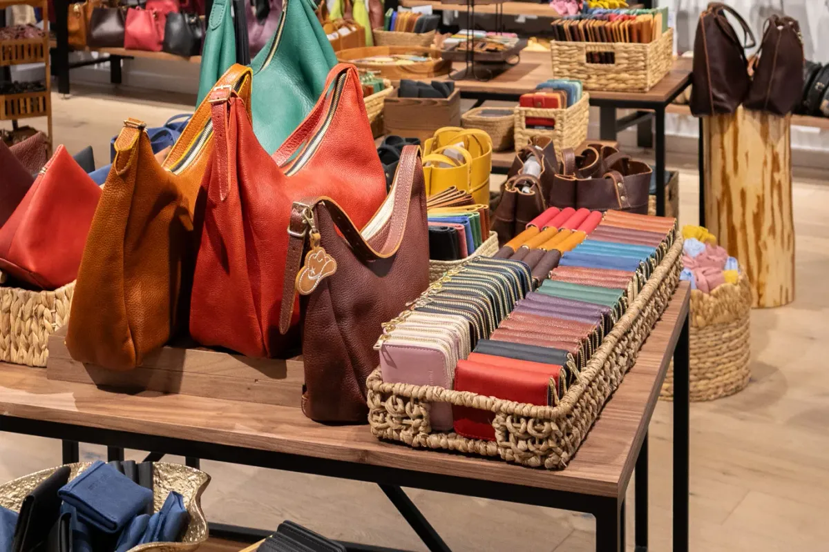 A display of leather handbags and wallets in a range of colours