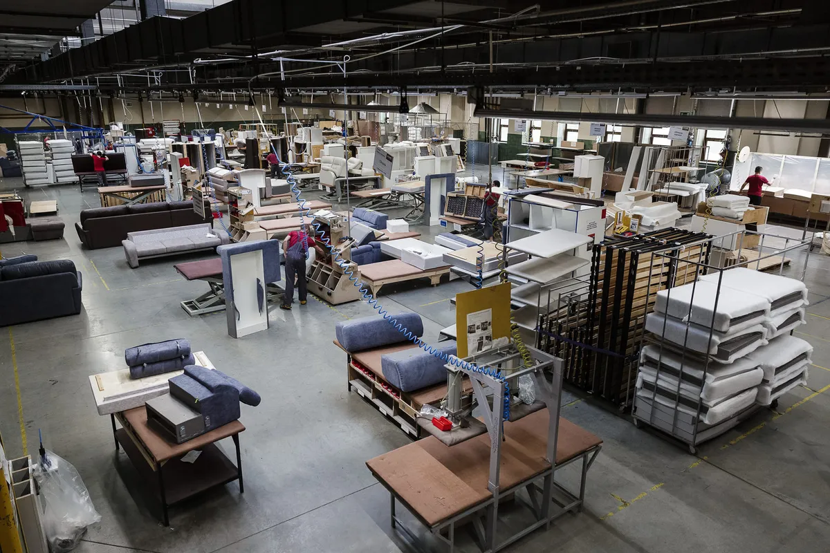 A wooden chair and furniture pieces in a workshop